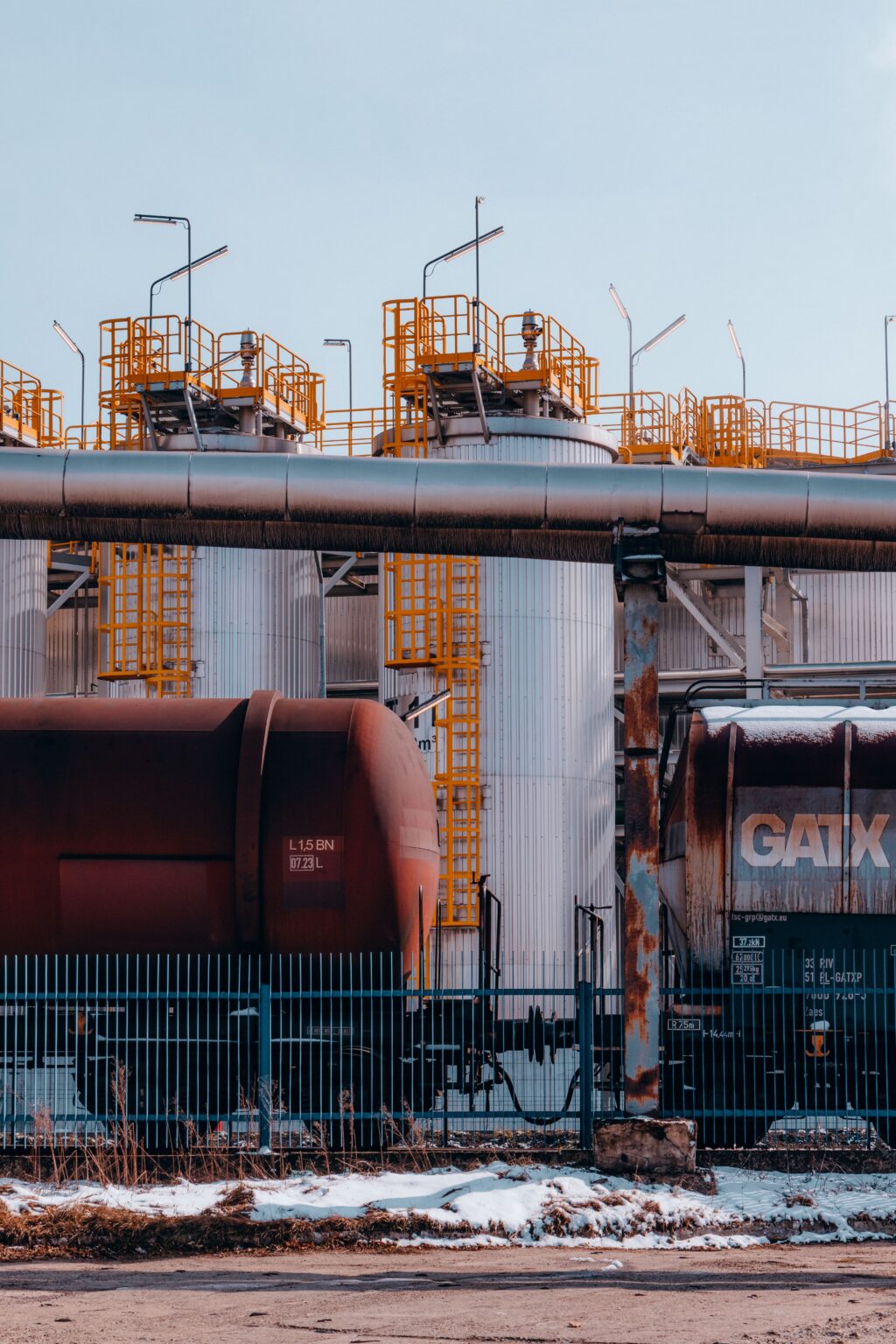 Freight train containers at refinery in Trzebinia, Poland highlighting industrial transport.