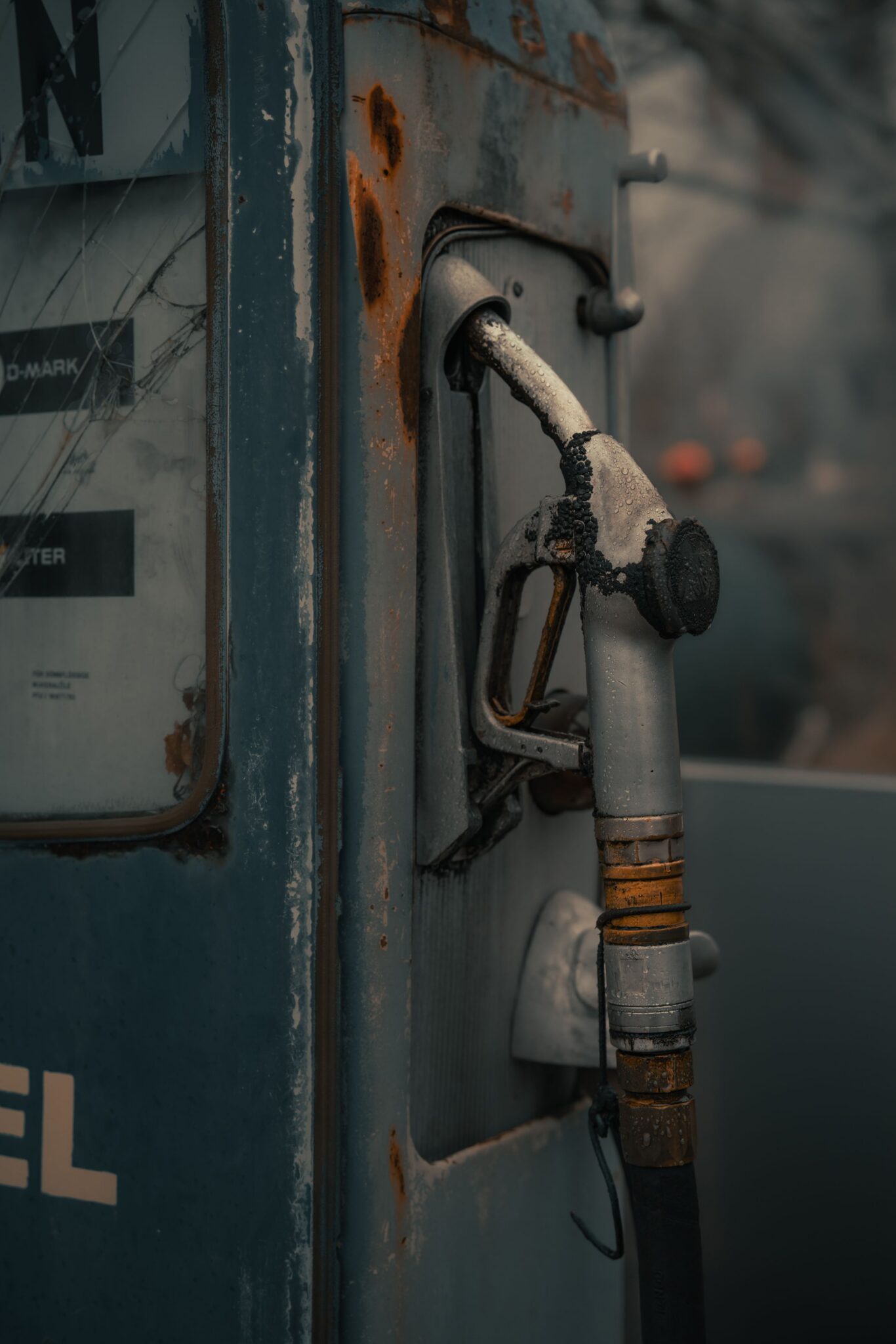 A close-up of a rusty, abandoned fuel pump at a gas station in Prackenbach, Germany.