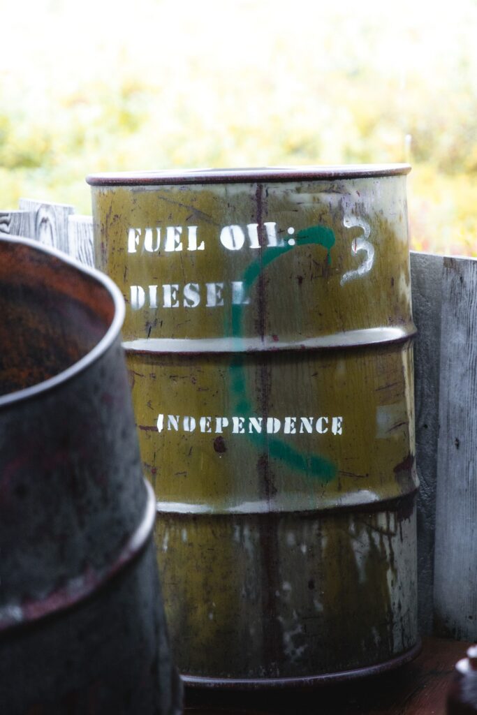 A weathered fuel oil barrel labeled "Diesel" and "Independence" in a rural setting.