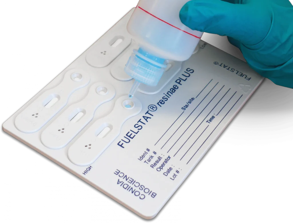 Conidia FUELSTAT Plus microbial fuel testing cassette with reagent being applied to sample well